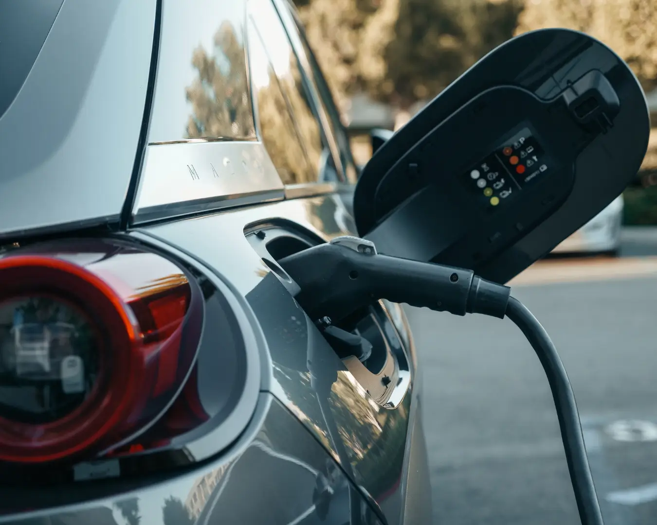 Electric vehicle charging station with multiple EVs plugged in, representing the growth of the electric vehicle market in Indonesia