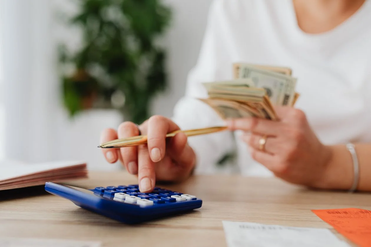 Person using a blue calculator — calculating proportional RBF installments