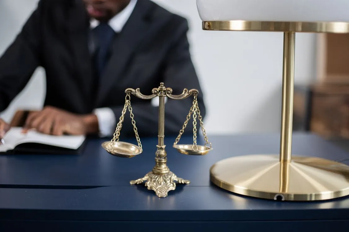 Golden scales of justice on a desk, symbolizing the legal basis of sharia financing